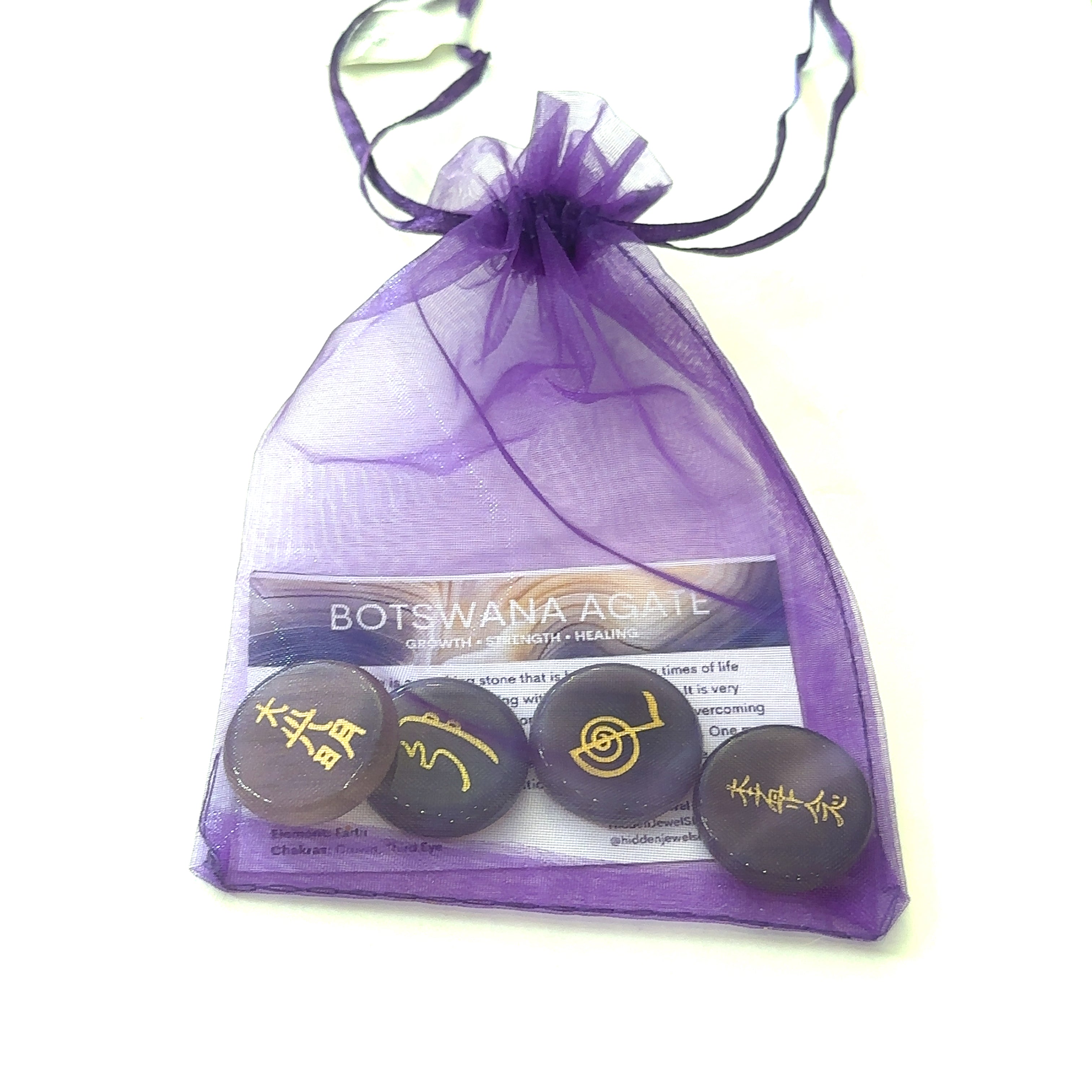 Botswana Agate Reiki stones displayed in Hidden Jewel gift bag tied with ribbon on a white background front view.