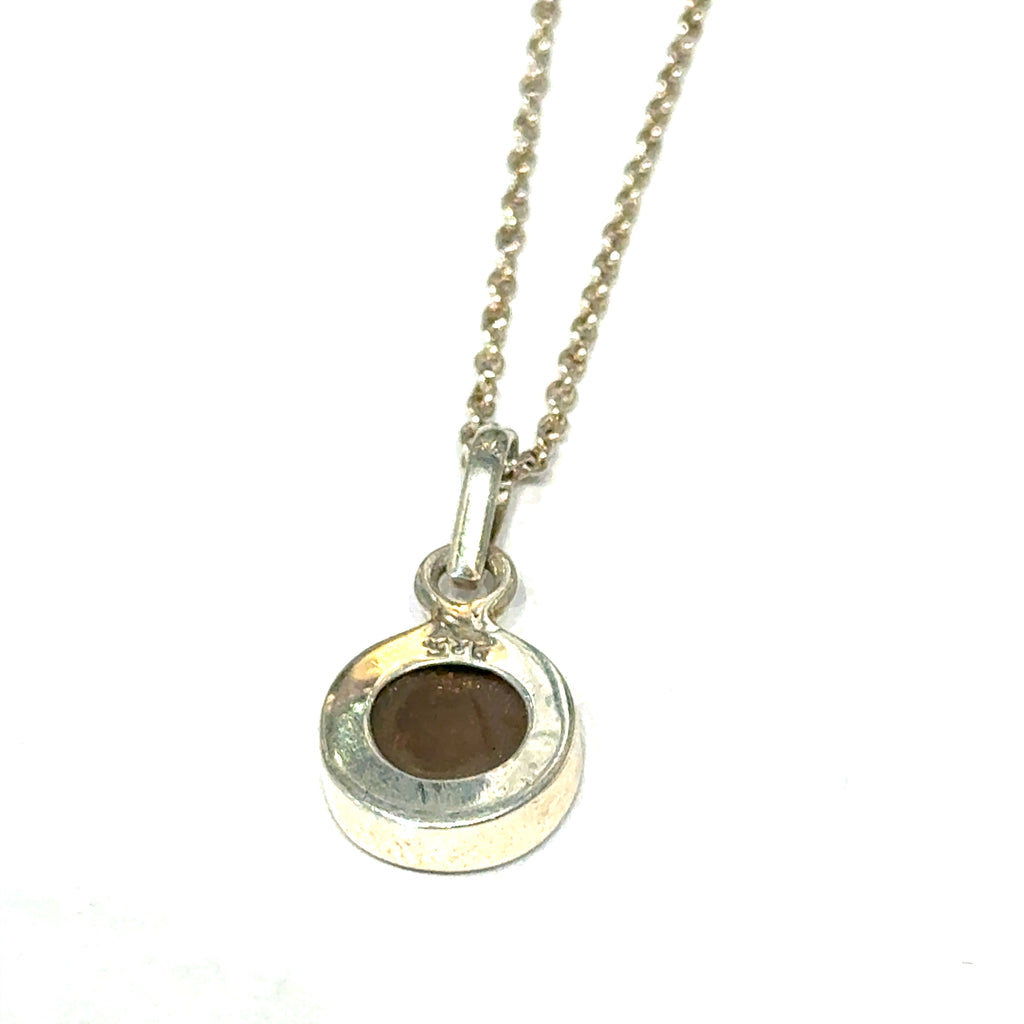 Brown Confetti Moonstone Sunstone pendant set in sterling silver bezel on a black background, hung, back overview. 