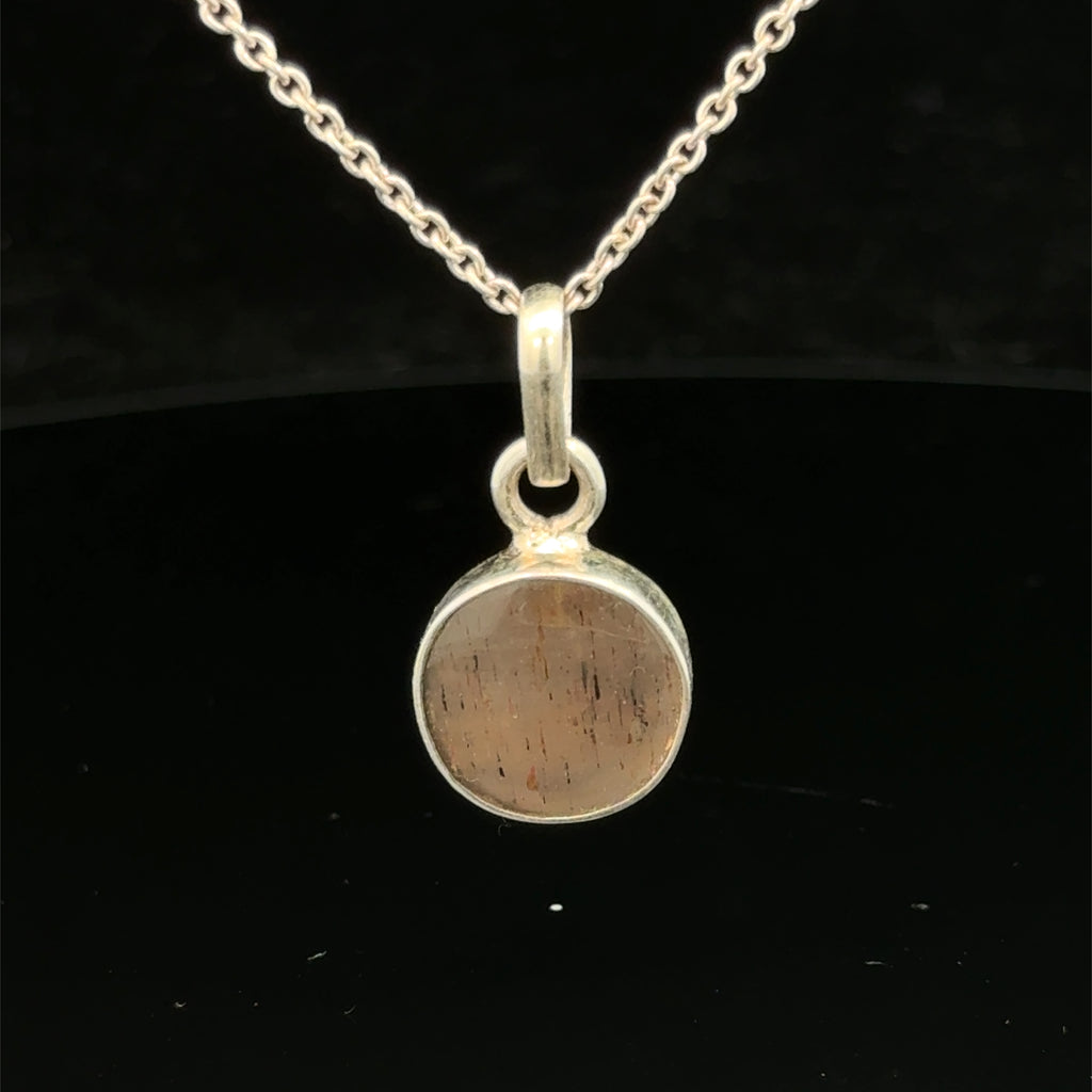Brown Confetti Moonstone Sunstone pendant set in sterling silver bezel on a black background, hung, front view. 