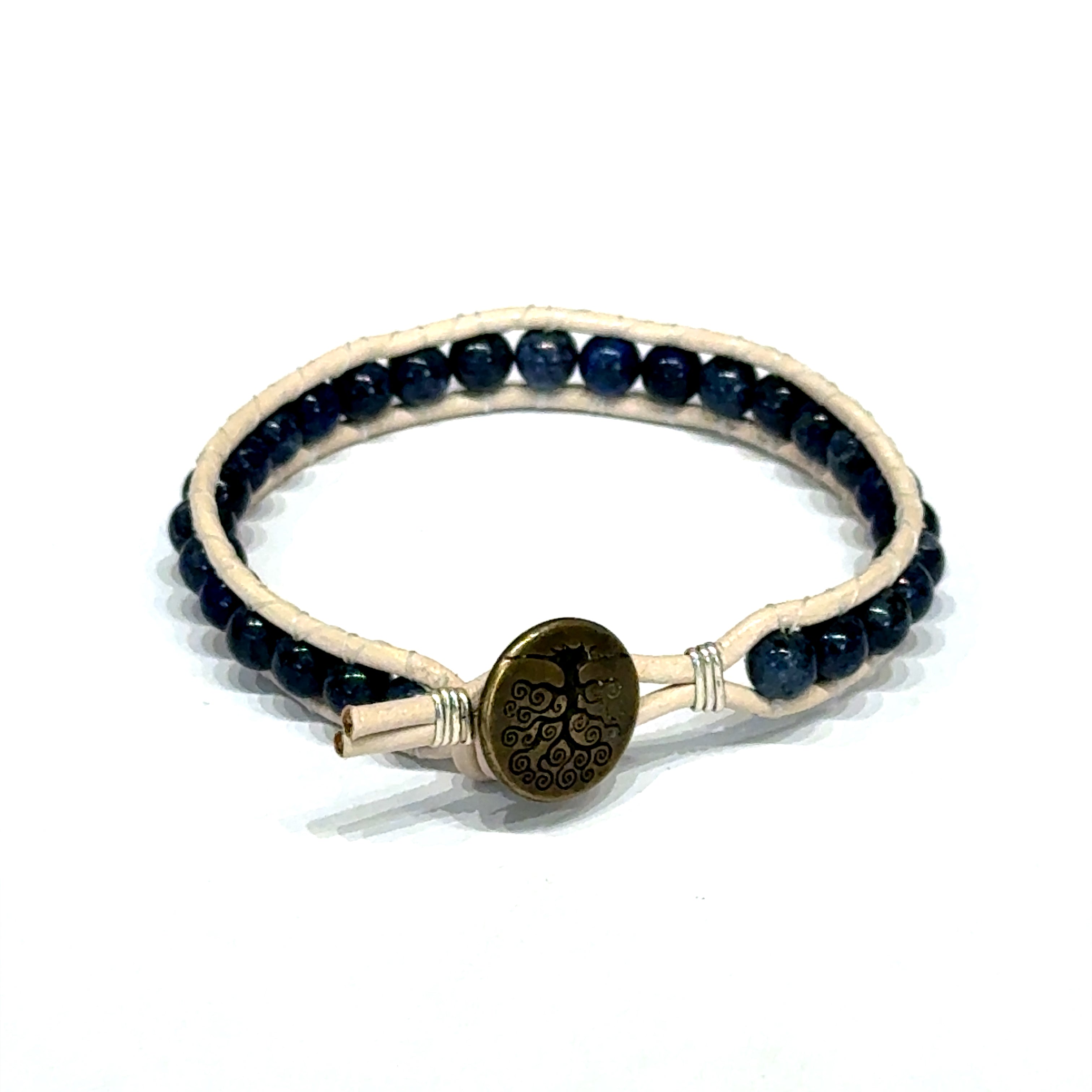 Chrysocolla gemstone leather wrap bracelet with copper Tree of Life button on a white background, button view.