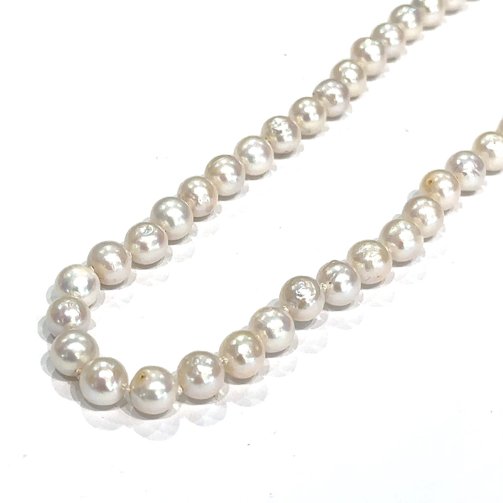 Classic freshwater pearl strand for weddings, anniversaries, and everyday wear on white long angled overview