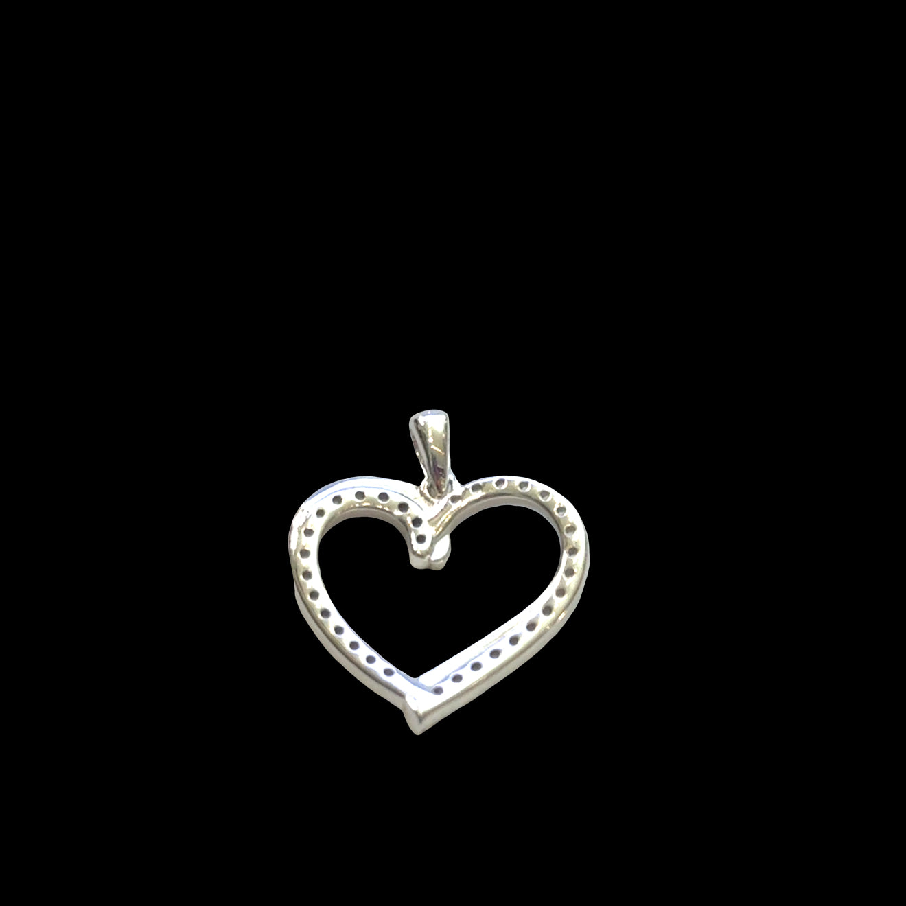 Classic sterling silver heart pendant with pavé cubic zirconia stones, 925 stamp, romantic love jewelry, 1 inch elongated heart, on a black background, back view. 