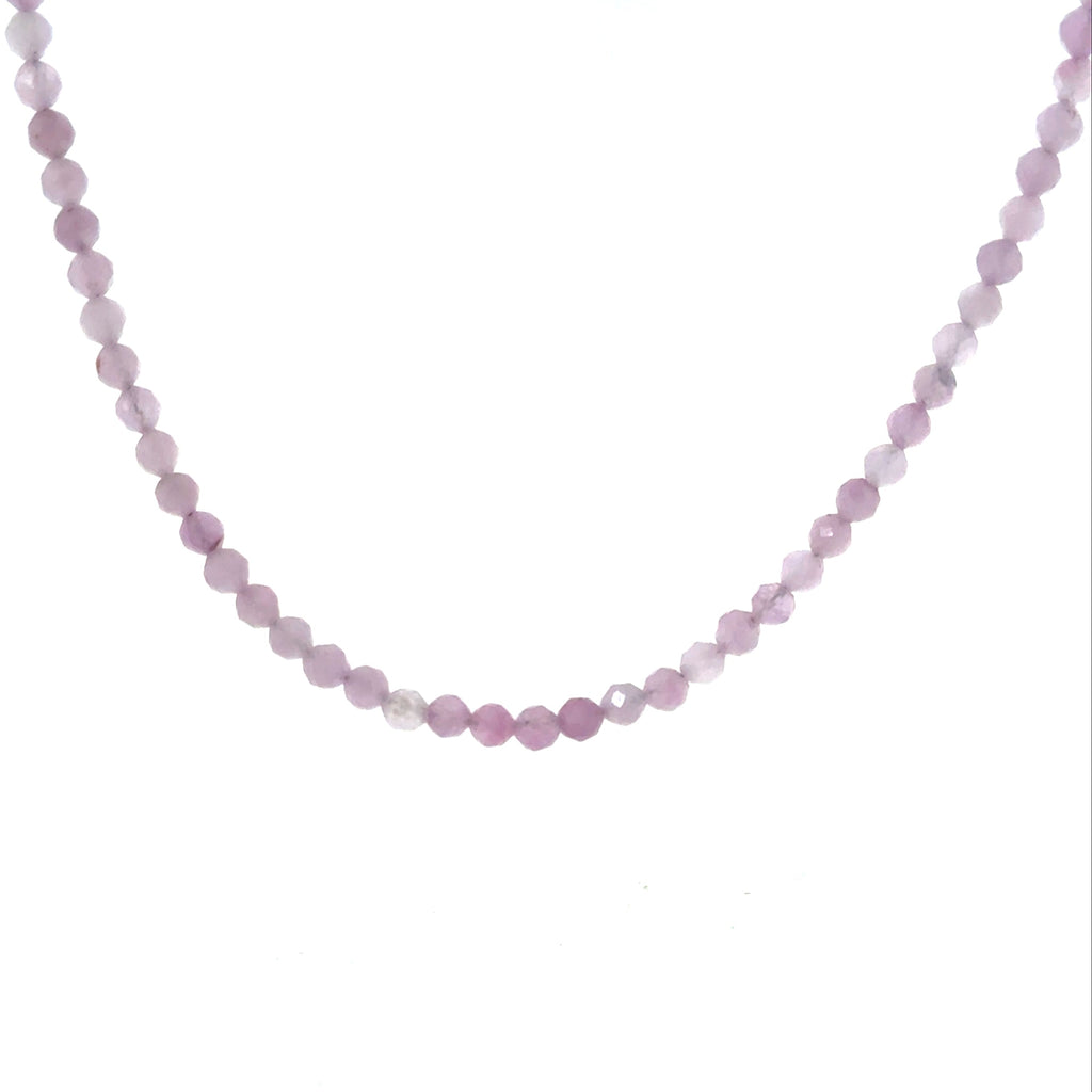 Close-up of 3mm micro-faceted round kunzite beads on Beadalon wire with sterling silver findings showing natural pink to lavender color shift, ethically sourced gemstone jewelry Boston