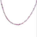 Close-up of 3mm micro-faceted round kunzite beads on Beadalon wire with sterling silver findings showing natural pink to lavender color shift, ethically sourced gemstone jewelry Boston