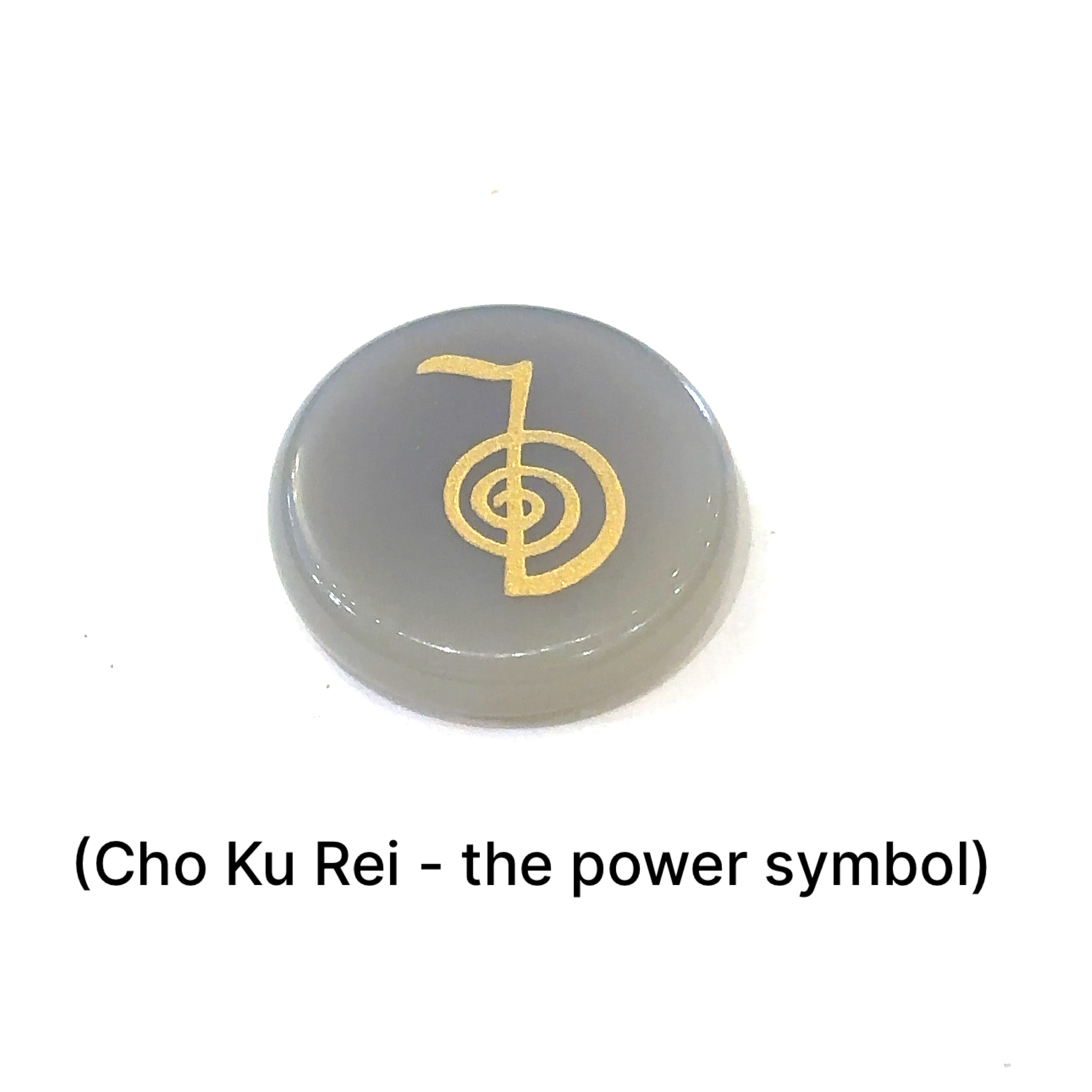 Close-up of Botswana Agate stone showing engraved Cho Ku Rei Power Symbol in gold on a white background front view. 