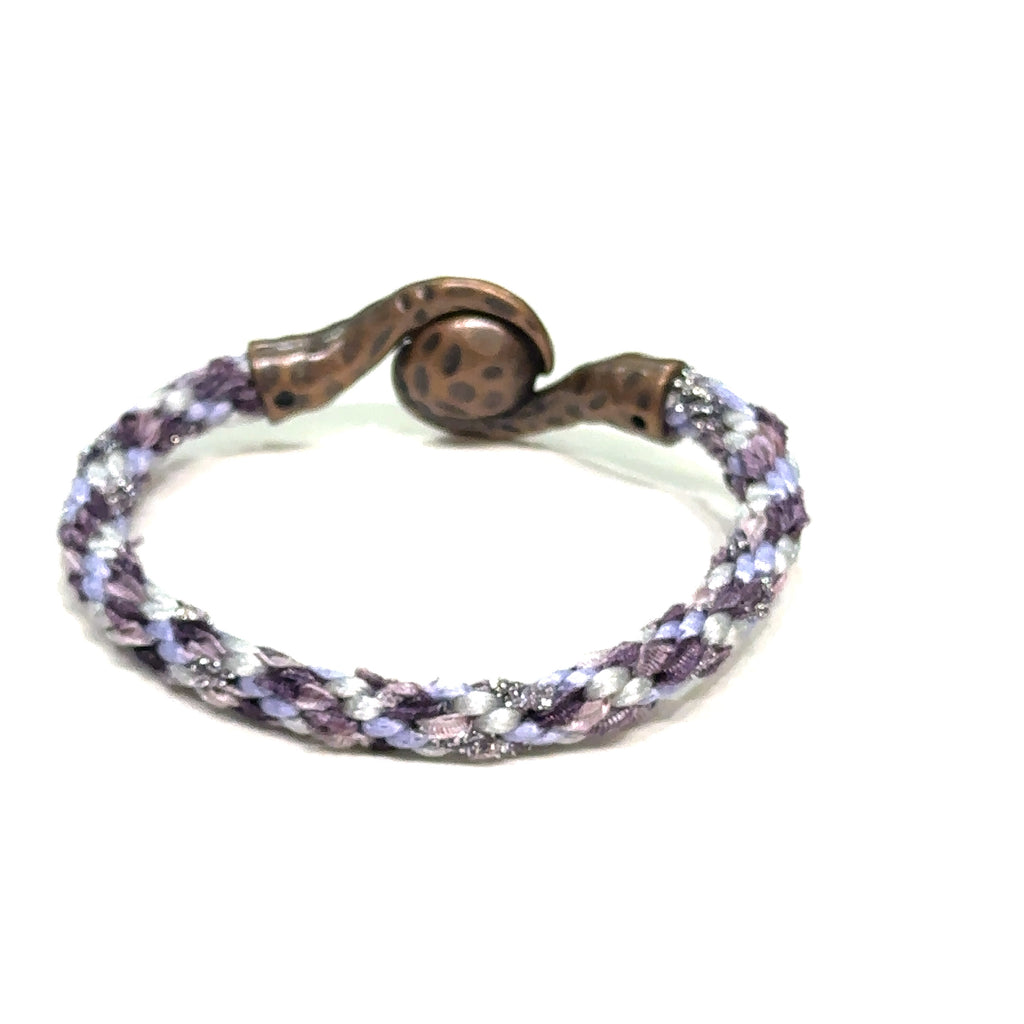 Close-up of Kumihimo braid showing woven texture and color detail purple bracelet  on white back view