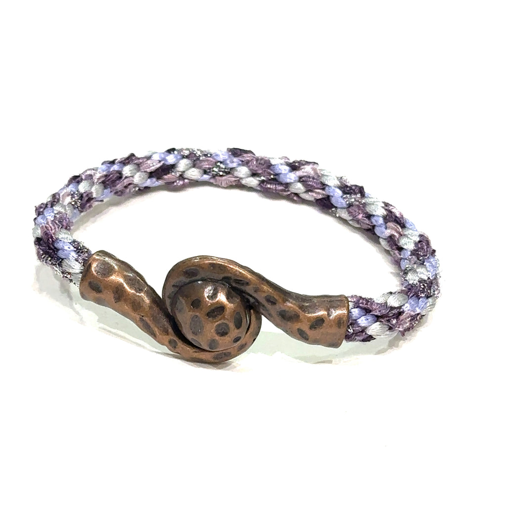Close-up of Kumihimo braid showing woven texture and color detail purple bracelet  on white left angle view