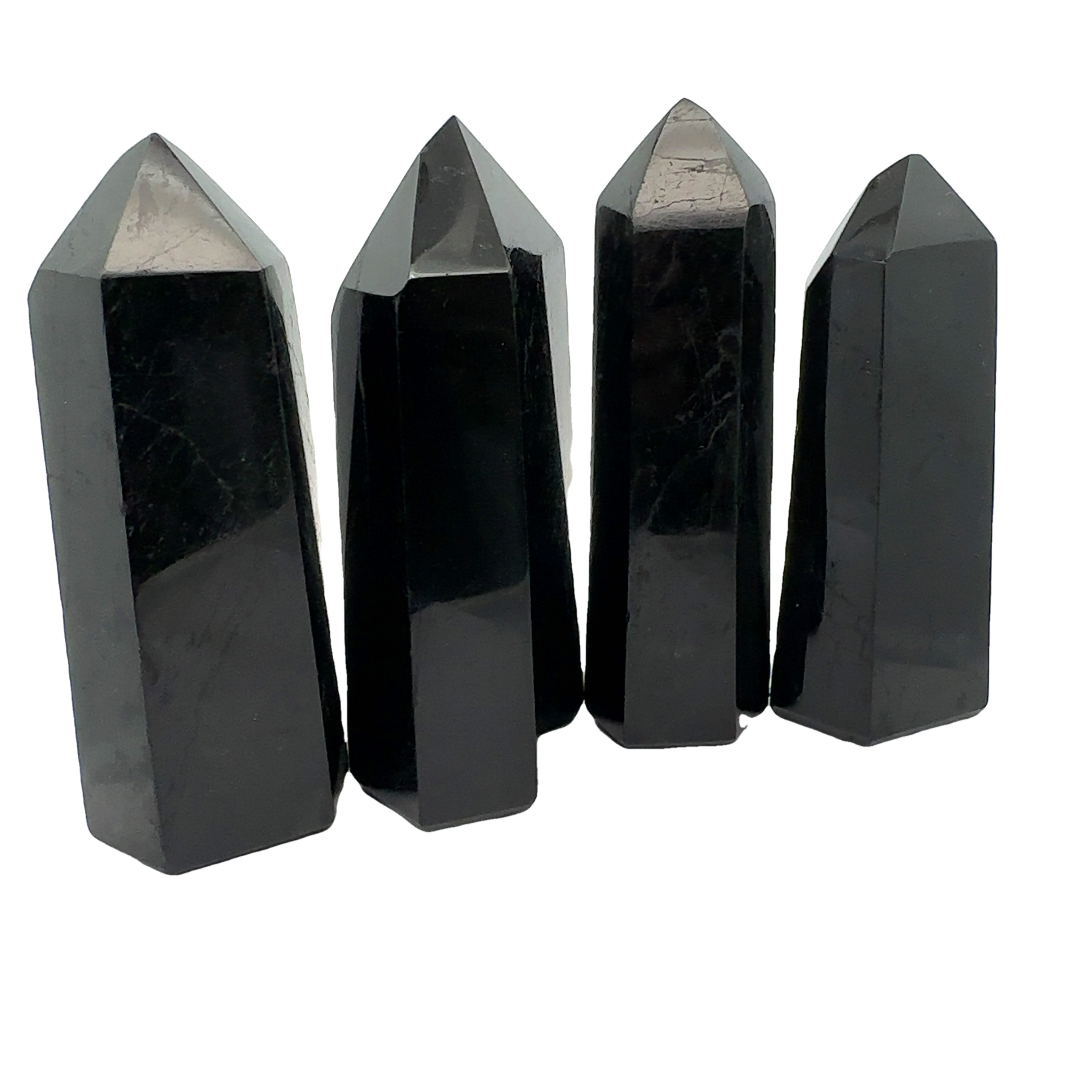 Close-up of a collection of Black Tourmaline crystal showing natural striations and deep black luster on a white background front view. 