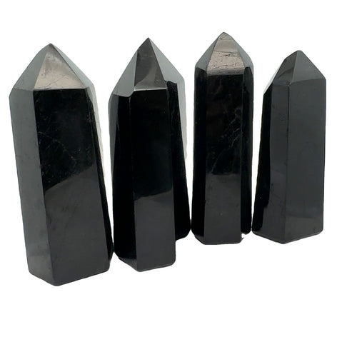 Close-up of a collection of Black Tourmaline crystal showing natural striations and deep black luster on a white background front view. 