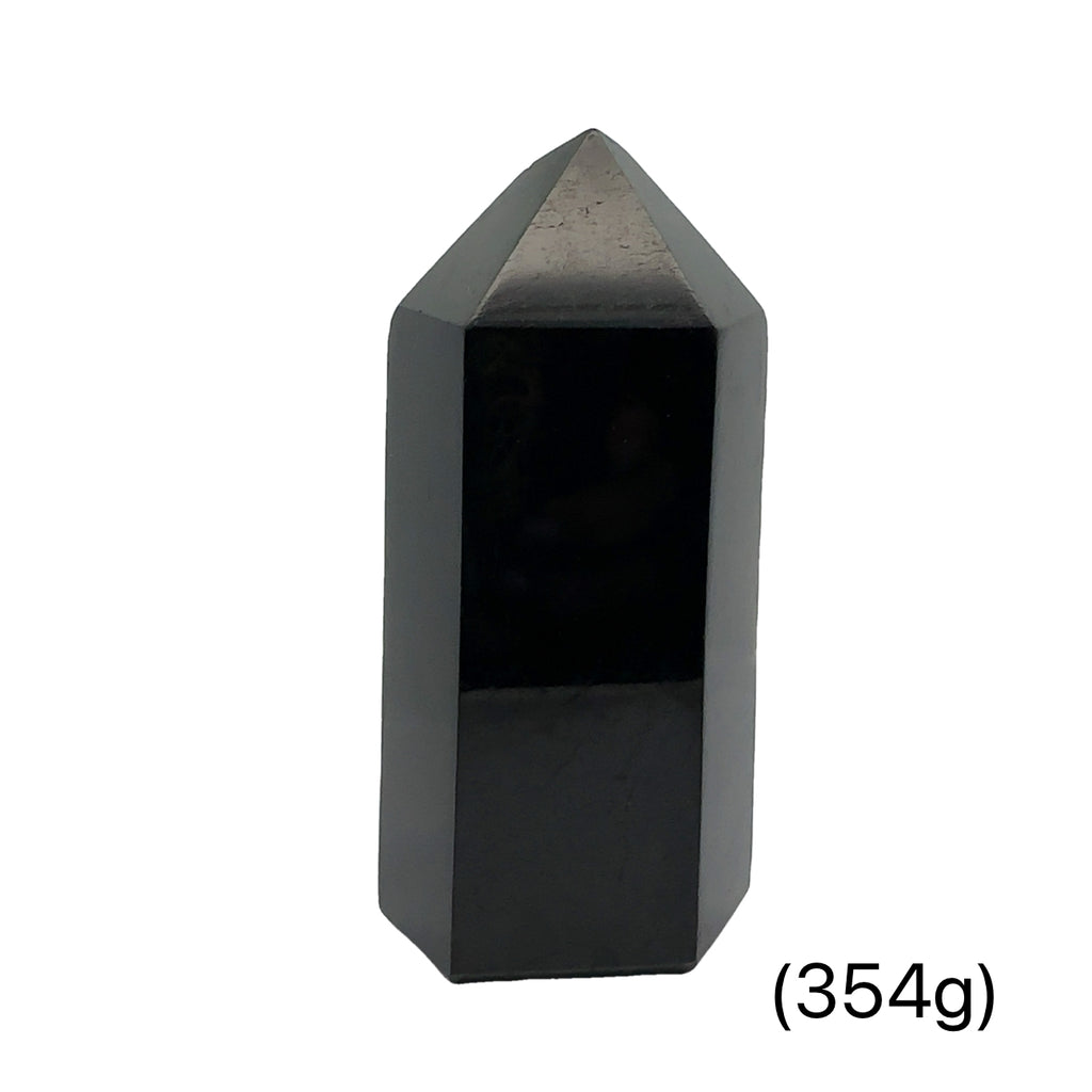 Close-up of a collection of Black Tourmaline crystal showing natural striations and deep black luster on a white background front view (354g)