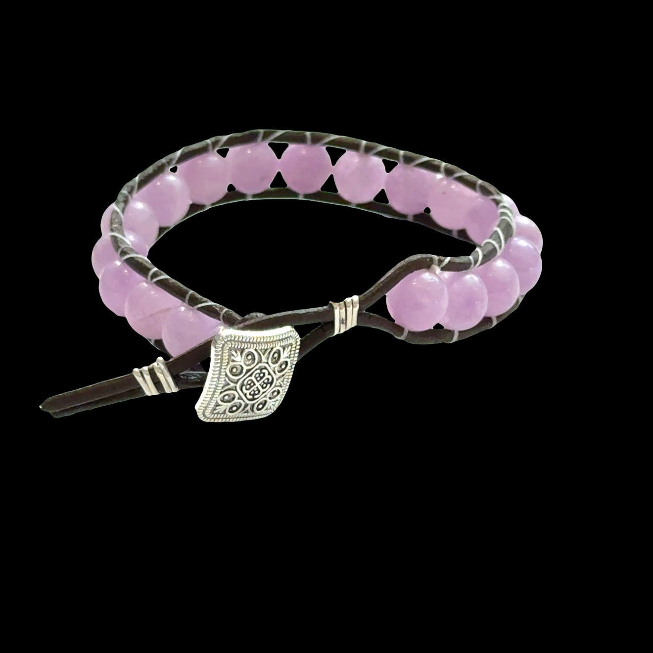 Close-up of genuine Lavender Jade beads showing soft purple and lavender hues, 8mm gemstone bracelet for emotional healing, on a black background, back view.