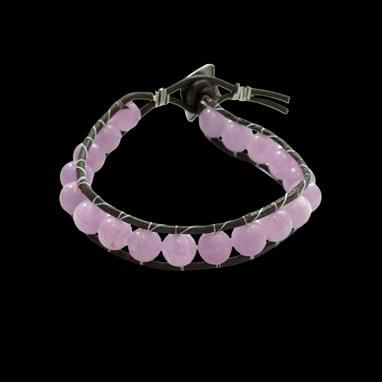 Close-up of genuine Lavender Jade beads showing soft purple and lavender hues, 8mm gemstone bracelet for emotional healing, on a black background, front view.