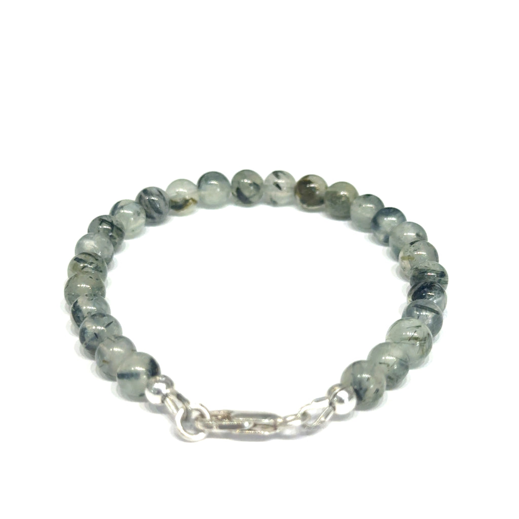 Close-up of natural prehnite beads displaying a soft green color and a smooth, polished finish, size 6.5, on a white background, back overview. 