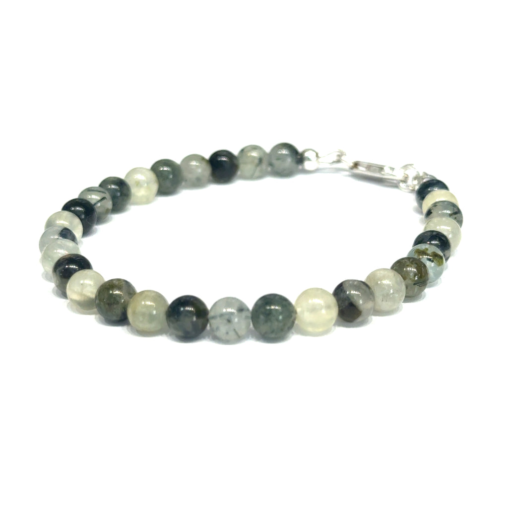Close-up of natural prehnite beads displaying a soft green color and a smooth, polished finish, size 7, on a white background, slight left angle overview. 