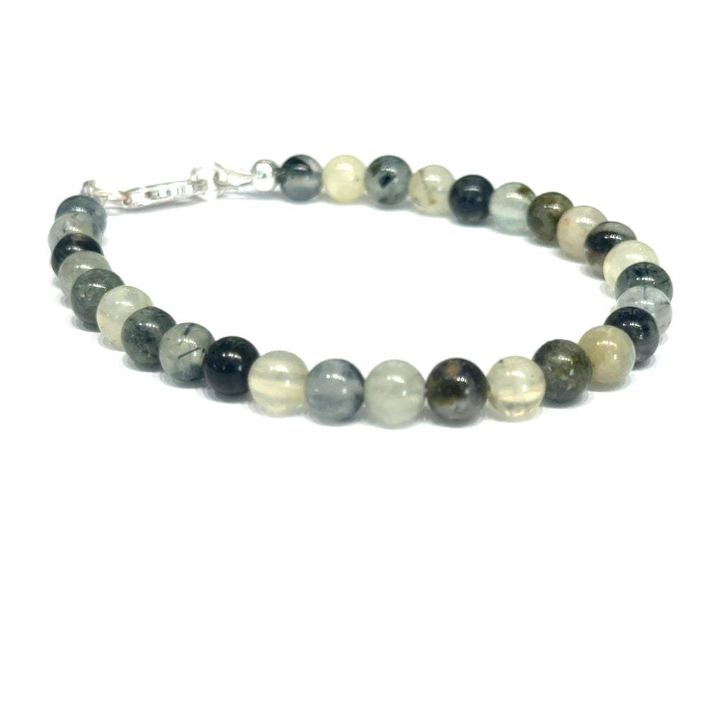Close-up of natural prehnite beads displaying a soft green color and a smooth, polished finish, size 7, on a white background, slight right angle overview. 
