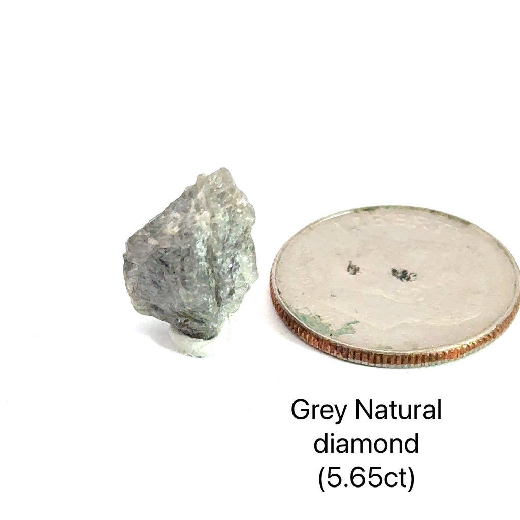 Close-up of natural uncut diamond showing raw crystalline surface and sparkle (Grey natural diamond 5.65ct) on white front view