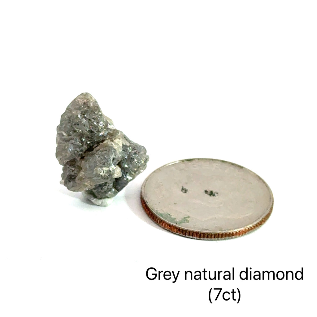 Close-up of natural uncut diamond showing raw crystalline surface and sparkle (Grey natural diamond 7ct)