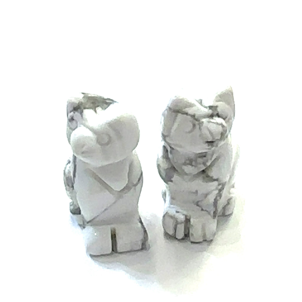 Close-up of polished gemstone cat  grouping of Howlite showing crystal texture and color variation. On white background front overview