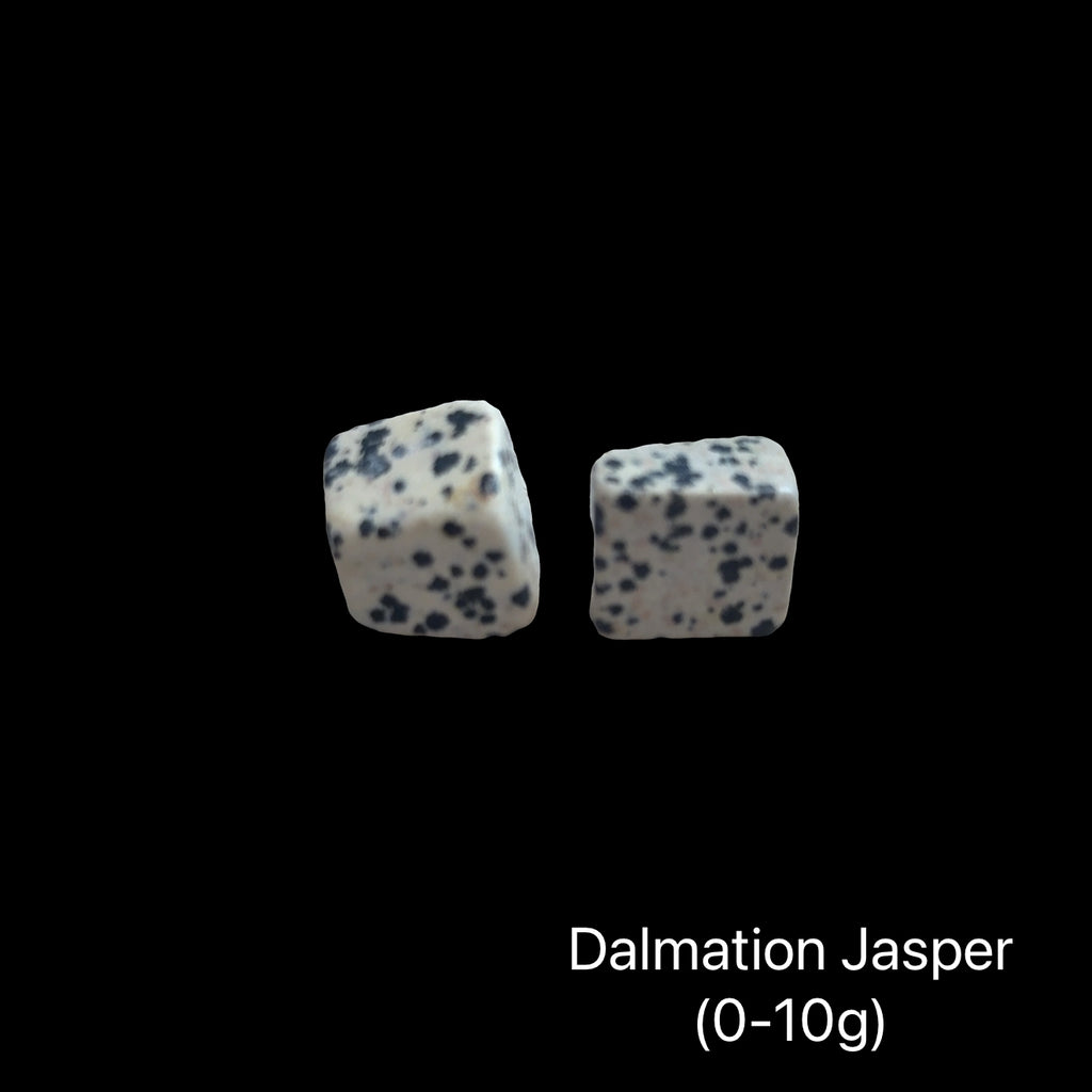 Dalmation Jasper stones with a weight range (0-10g) on a black background, front view.