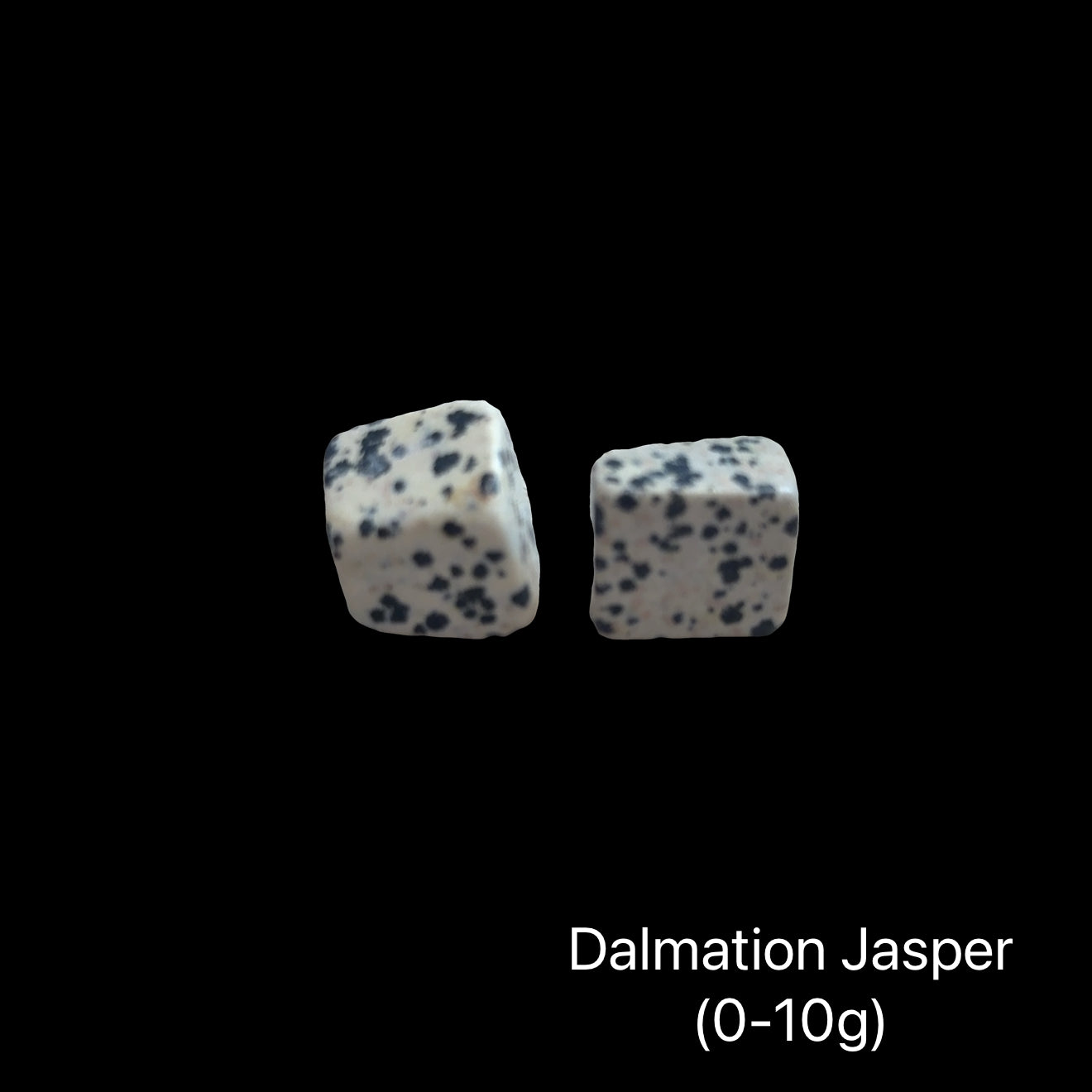 Dalmation Jasper stones with a weight range (0-10g) on a black background, front view.