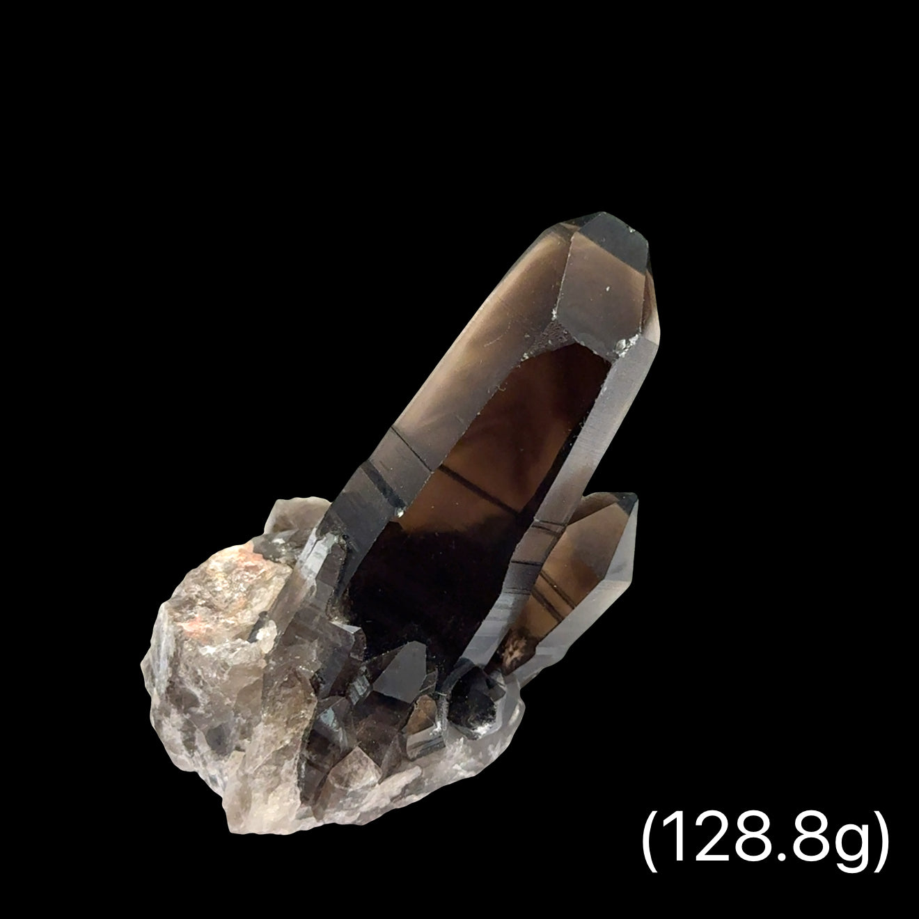 Deep smoky gray Quartz cluster with crystalline structure for electromagnetic protection weighs (128.8g), on a black background, front view.