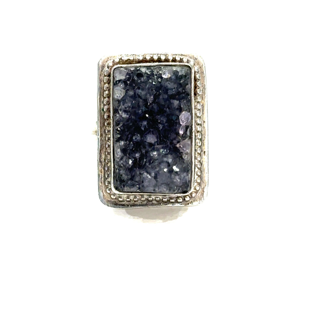 Detailed close-up of natural Amethyst druzy crystal showing purple sparkle and raw texture on white front center view