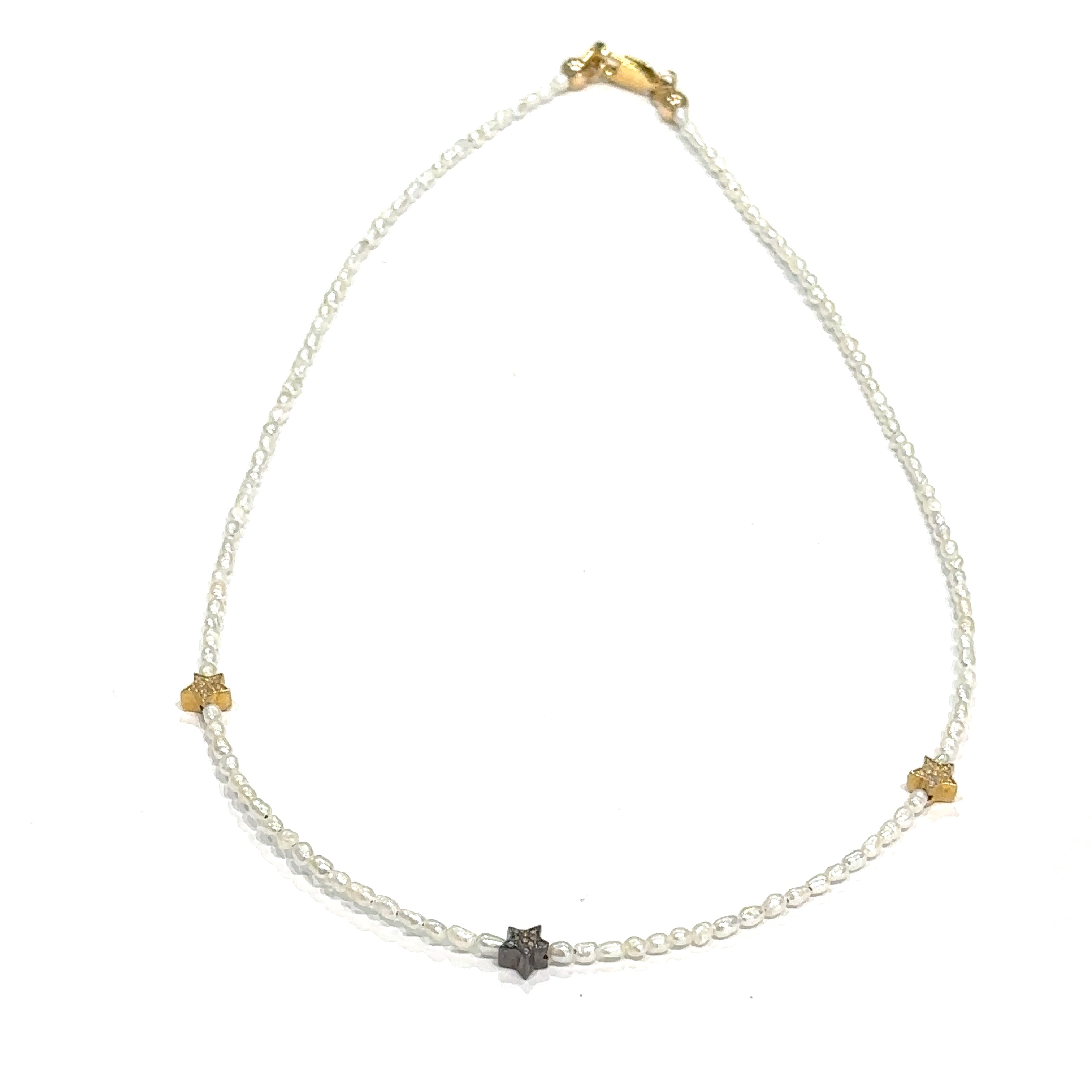 Elegant 16 inch pearl choker with rice pearls and celestial stars on white front view 
