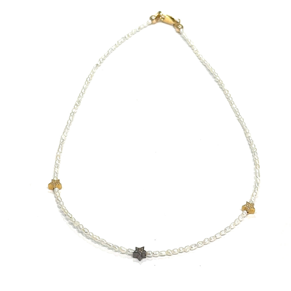 Elegant 16 inch pearl choker with rice pearls and celestial stars on white front view 