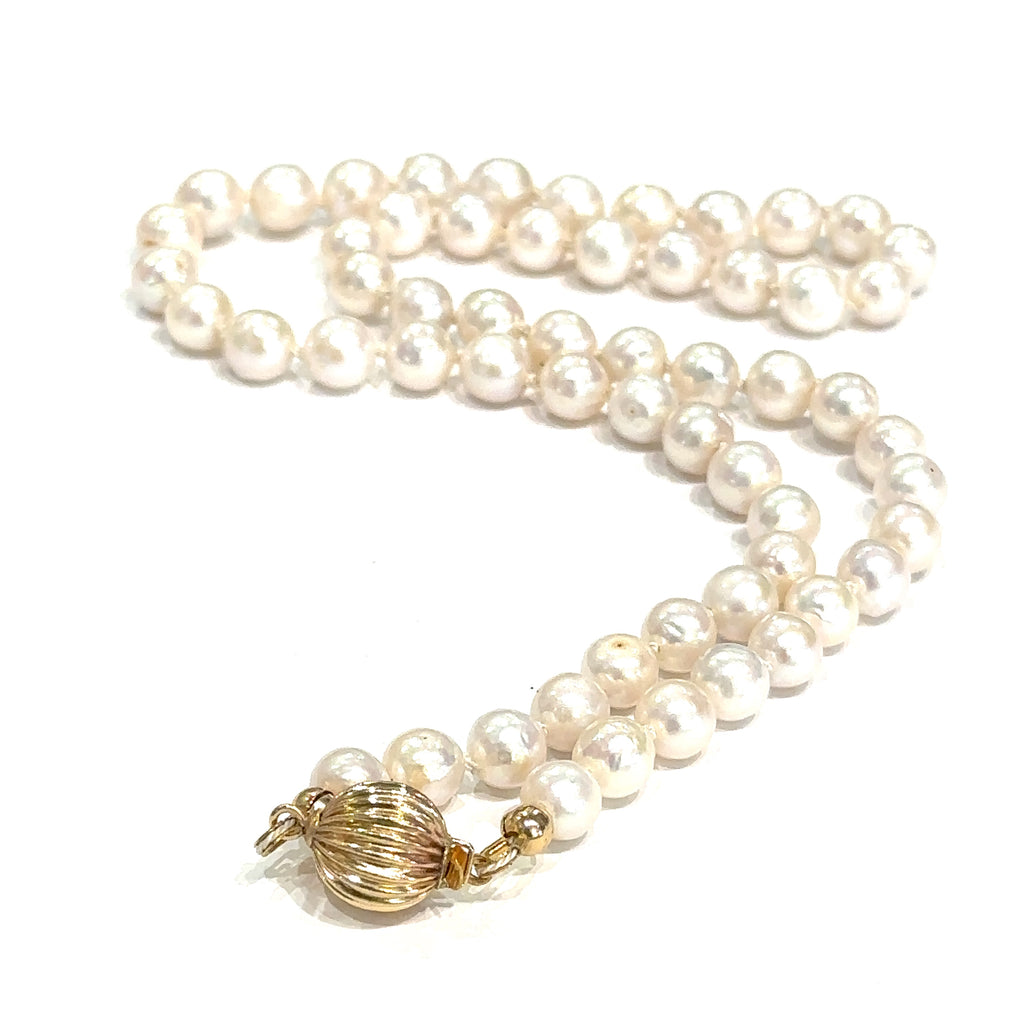 Elegant 18 inch freshwater pearl necklace with irregularly round pearls on white center up back close overview