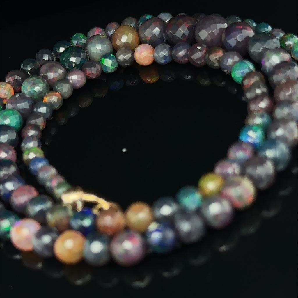 Elegant Ethiopian Black Opal necklace for courage, manifestation, and optimism on black spiral close up view