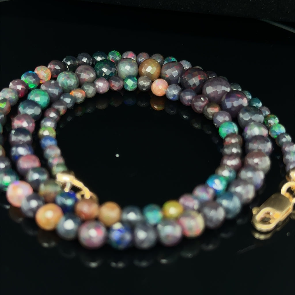 Elegant Ethiopian Black Opal necklace for courage, manifestation, and optimism on black spiral overview