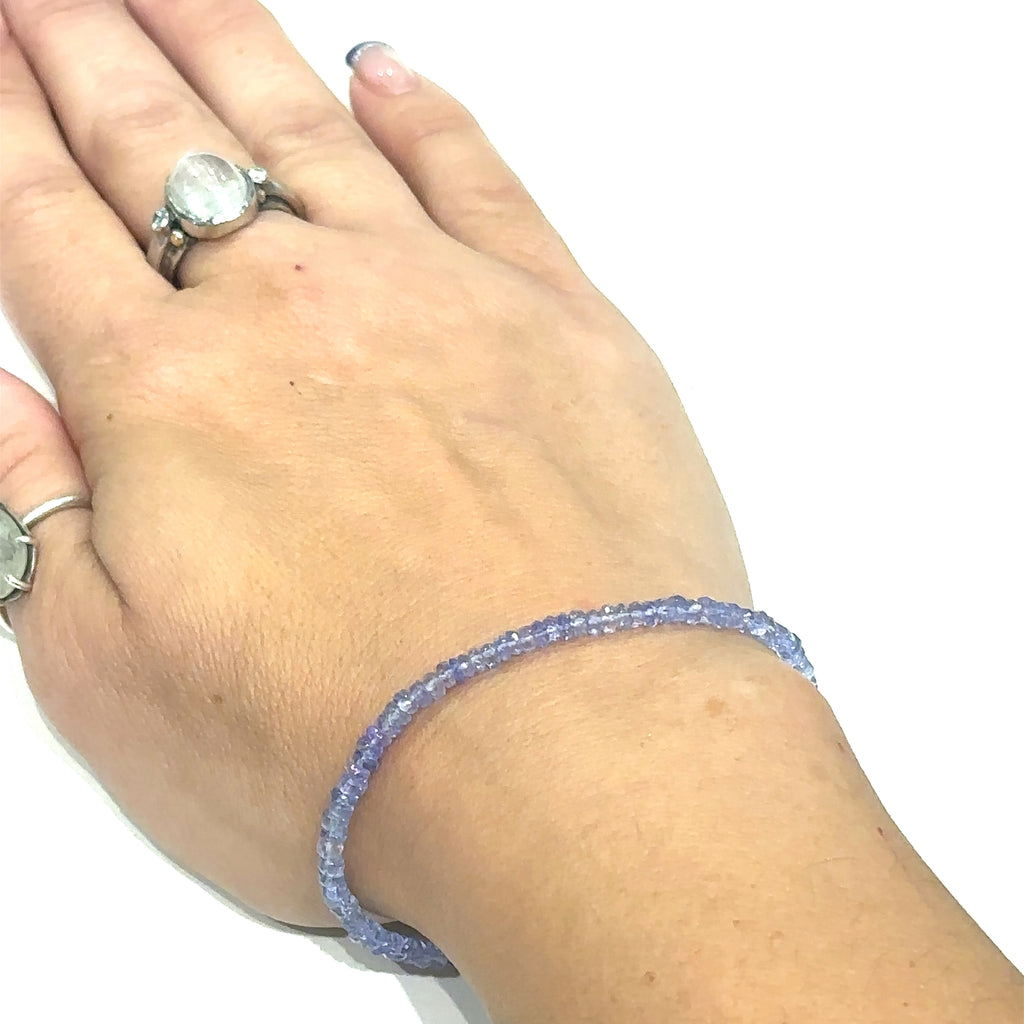 Elegant Tanzanite crystal bracelet for intuition, meditation, and spiritual awakening on wrist on white overview 