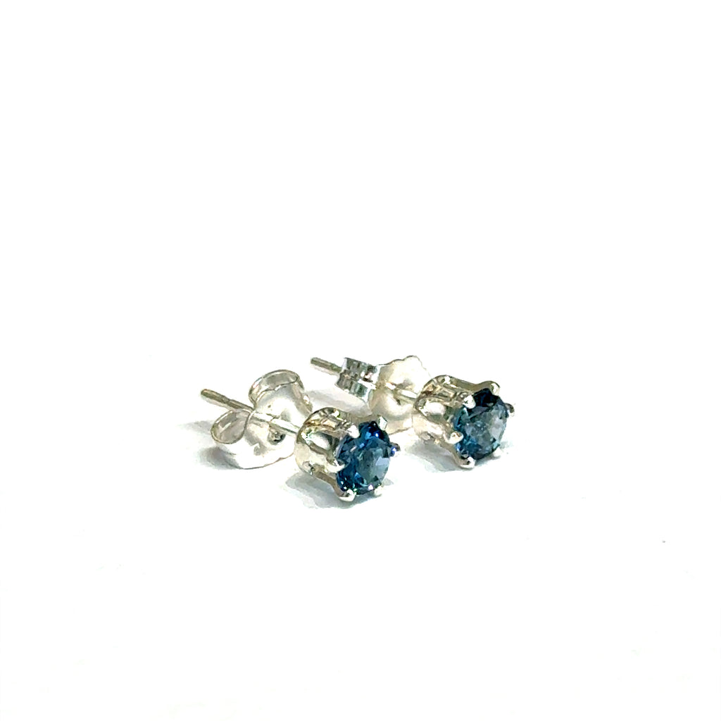 Elegant handmade London Blue Topaz earrings for the November birthstone gift on a white background, right angle font overview.