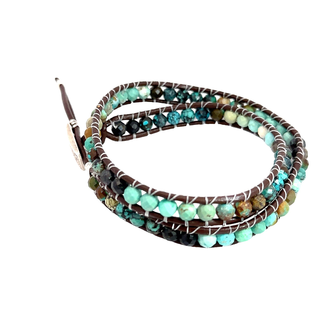 Elegant turquoise and leather wrap bracelet for chakra alignment and emotional balance on white side overview