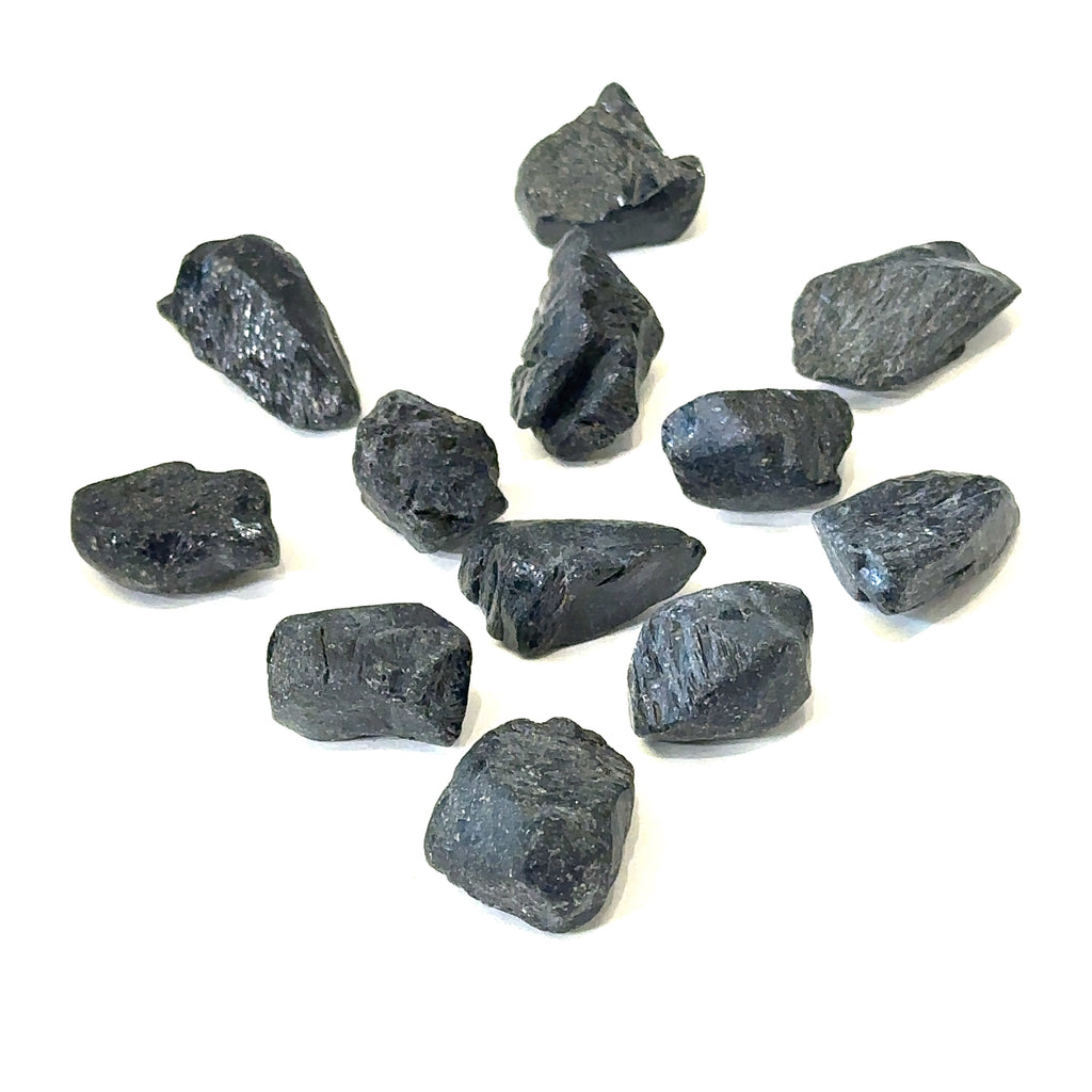 Ethically sourced raw Black Spinel gemstone with natural dark luster grouping on white overview