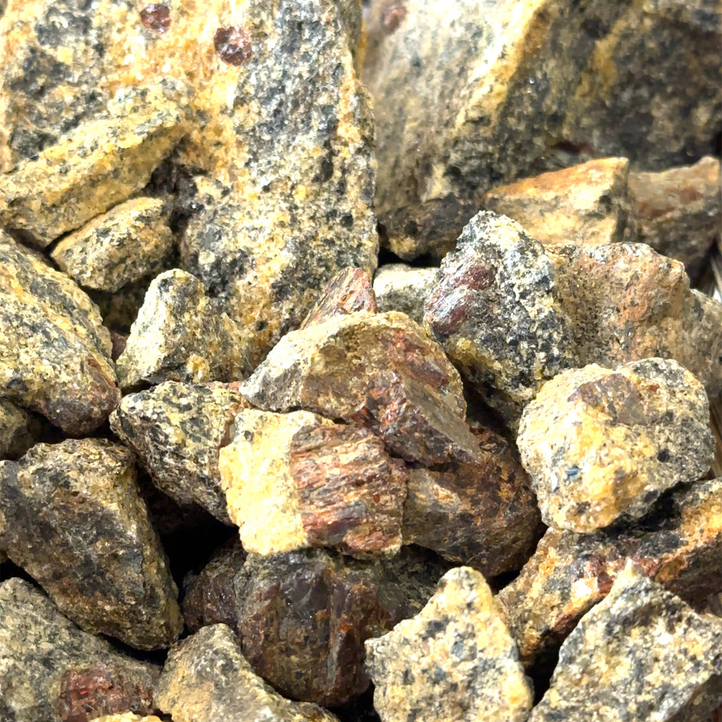 Ethically sourced raw Garnet gemstone mined from Gore Mountain Adirondacks grouping on white close up view