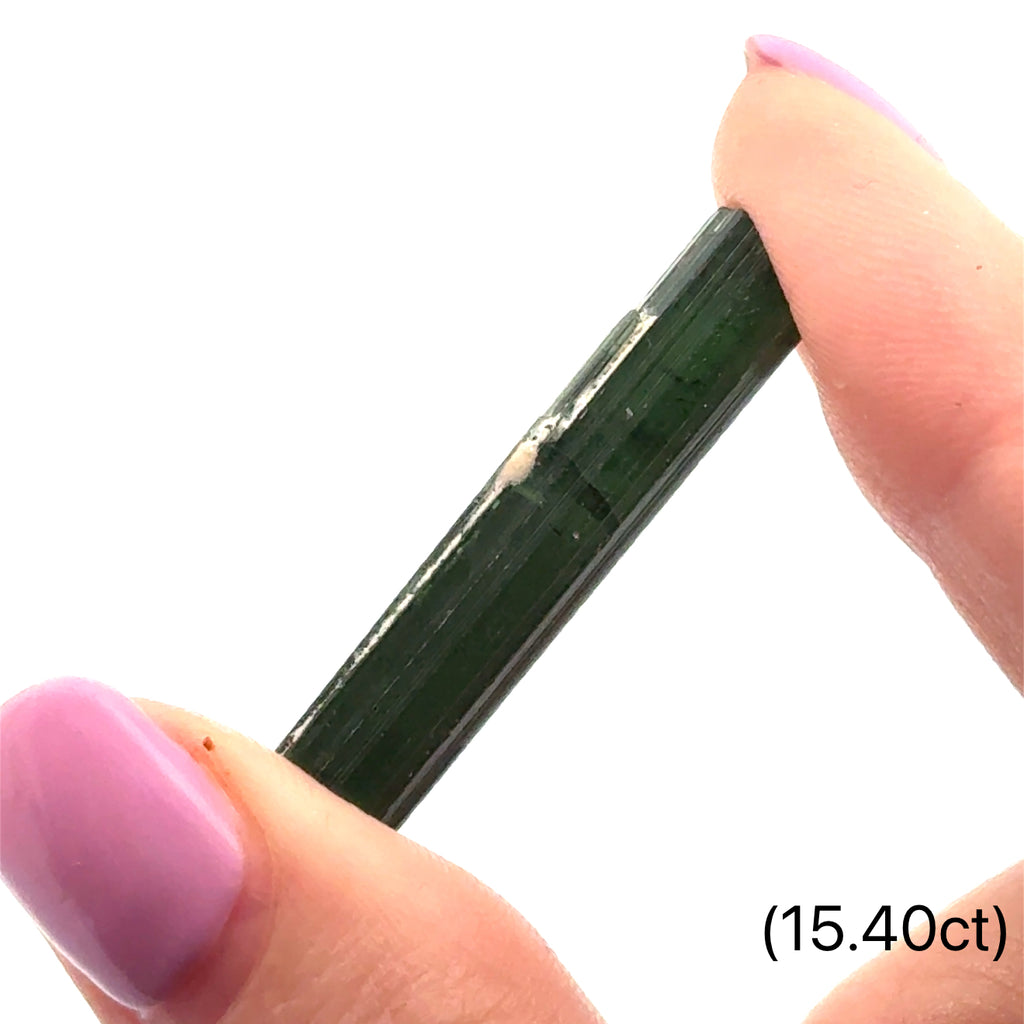 Ethically sourced raw Green Tourmaline gemstone with natural green hues (15.40ct) on white and in finger tips front view