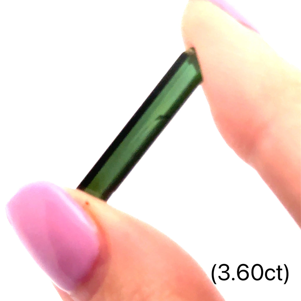 Ethically sourced raw Green Tourmaline gemstone with natural green hues (3.60ct) on white and in finger tips front view