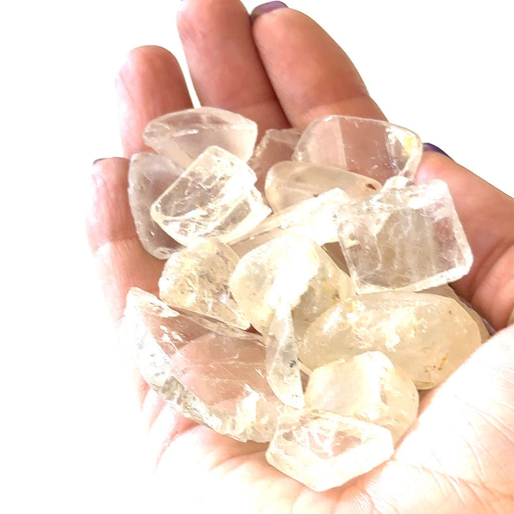 Ethically sourced raw White Topaz gemstone with natural brilliance grouping of gemstones in hand to show close up overview