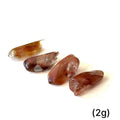 Ethically sourced tumbled Amphibole Quartz gemstone with unique inclusions grouping of (2g) on white overview