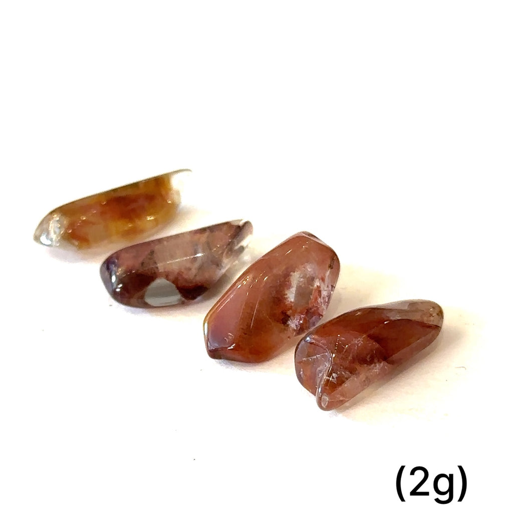 Ethically sourced tumbled Amphibole Quartz gemstone with unique inclusions grouping of (2g) on white overview