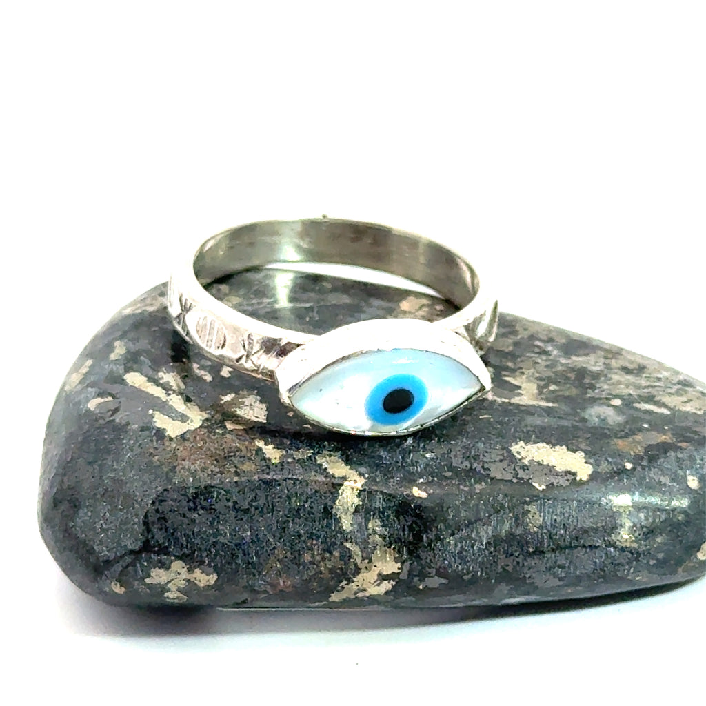 Evil‑Eye Mother‑of‑Pearl Ring on rock on white front view
