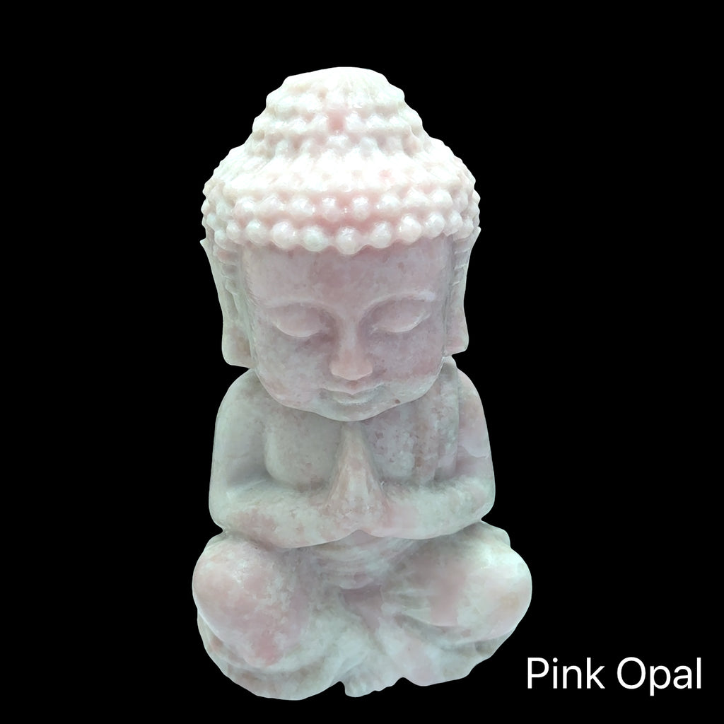 Extra-large pink opal Buddha statue with peachy-pink translucence and serene features, shown in front view on a black background. 