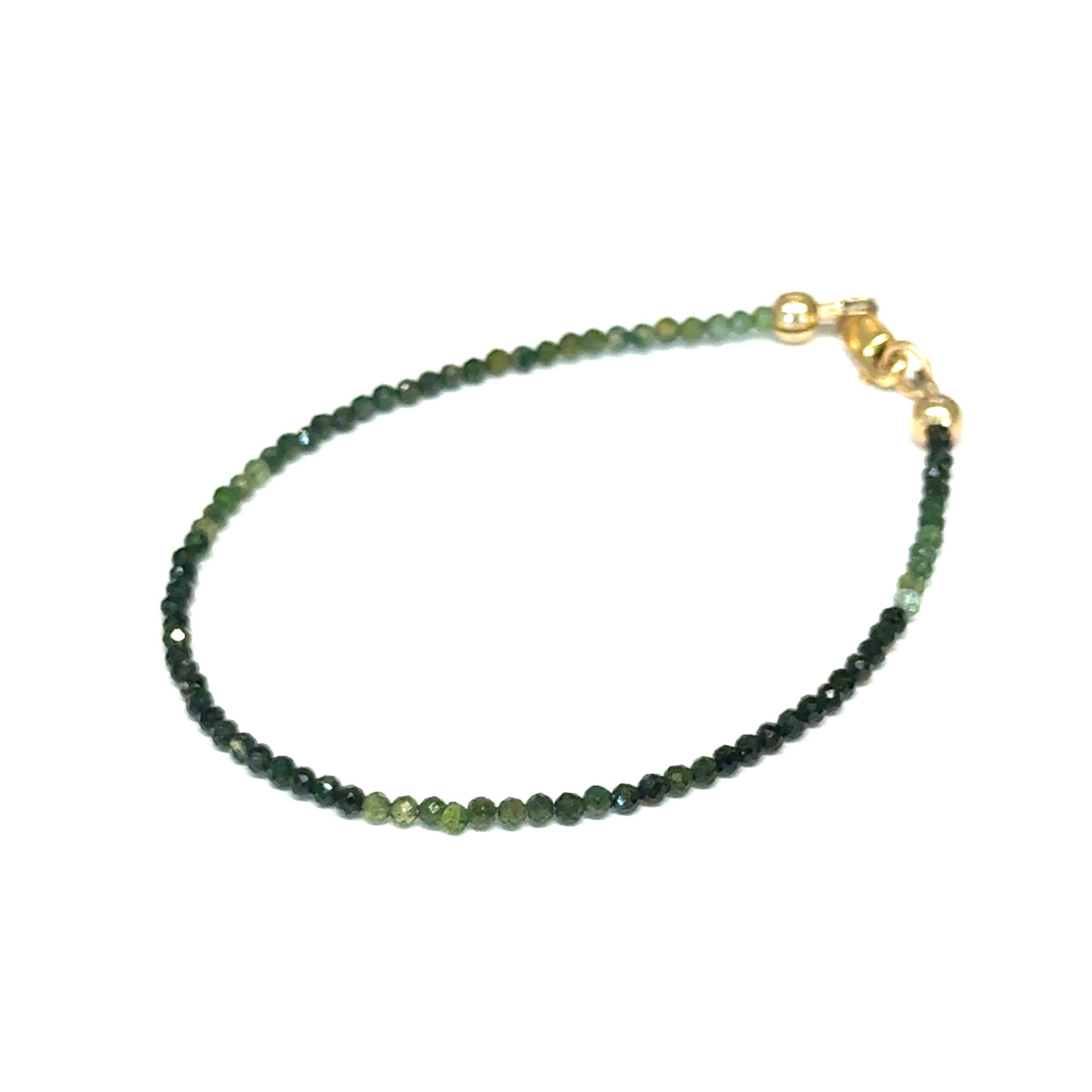 Faceted green tourmaline gemstone bracelet with gold-filled lobster claw clasp on white background, front left angle overview.