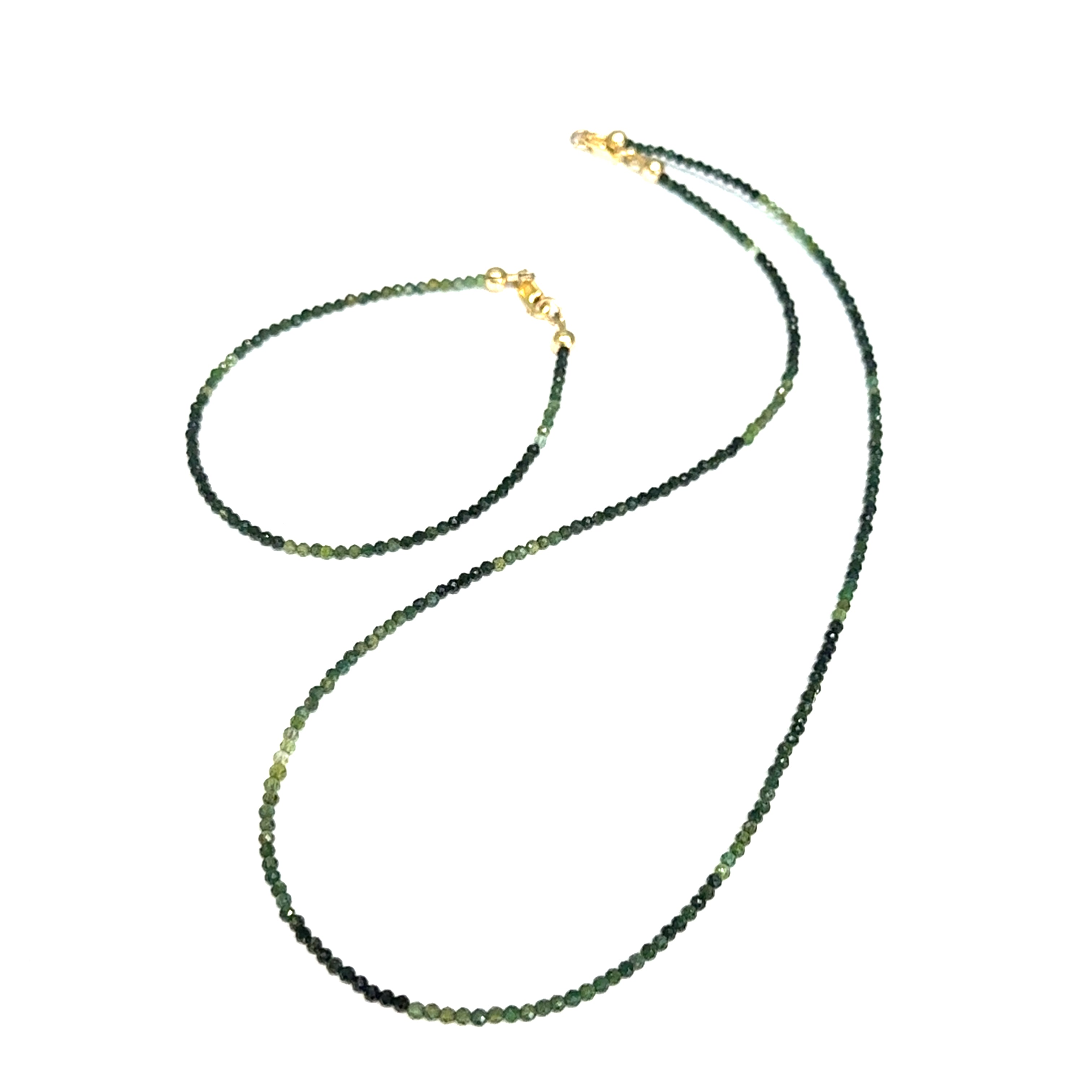 Faceted green tourmaline gemstone bracelet with gold-filled lobster claw clasp on white background, front left angle overview with it's matching necklace.