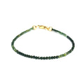 Faceted green tourmaline gemstone bracelet with gold-filled lobster claw clasp on white background, front view.
