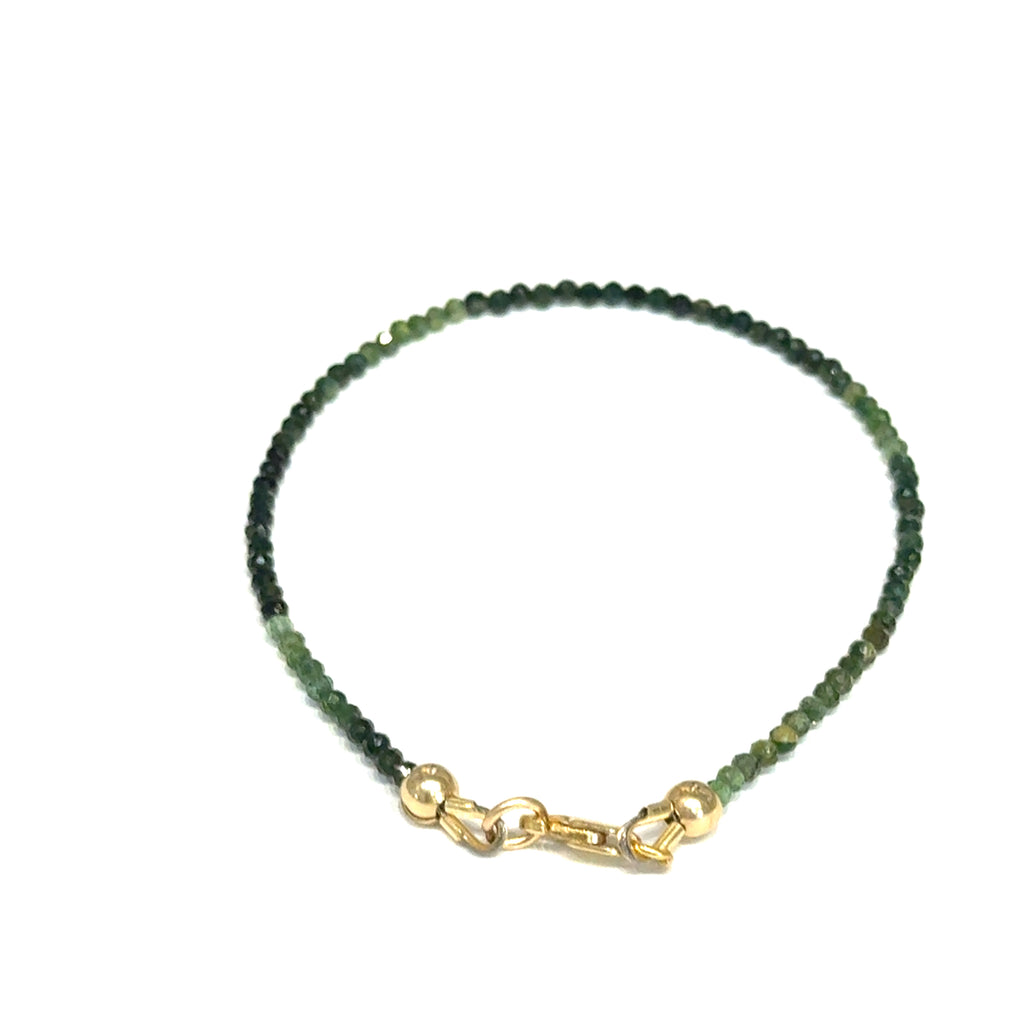 Faceted green tourmaline gemstone bracelet with gold-filled lobster claw clasp on white background, lobster claw overview.