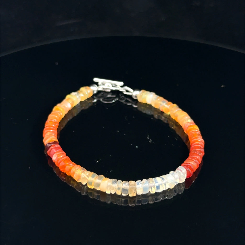 Fire Opal Gemstone bracelet  on a black top 