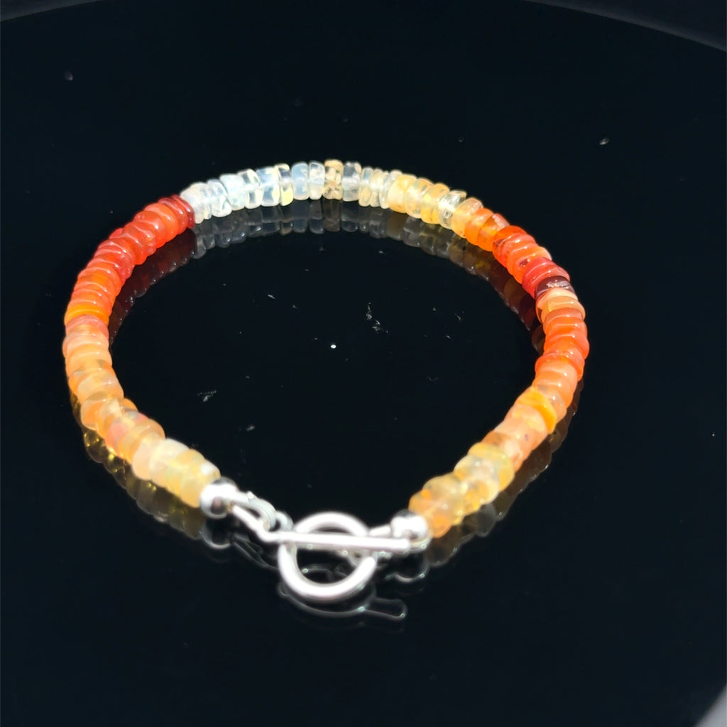 Fire Opal Gemstone bracelet  on a black top side