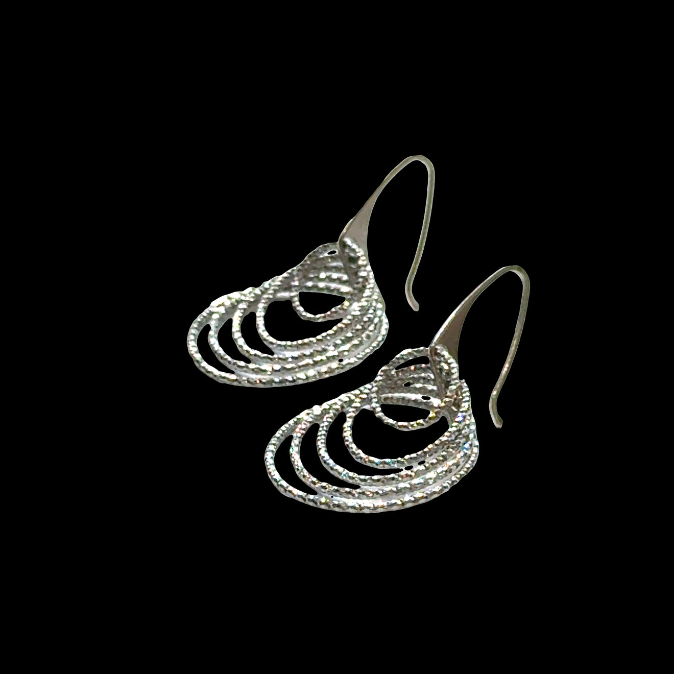 Five-circle graduated sterling silver earrings with diamond-cut finish on black background, front overview. 